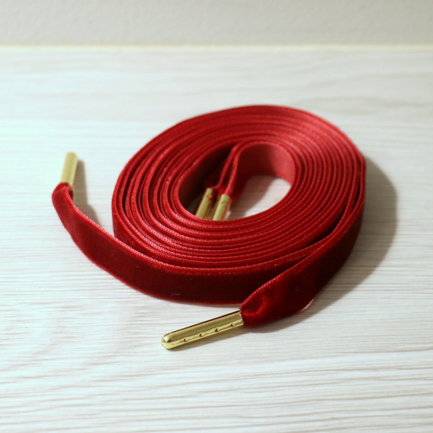 Red velvet shoelaces with gold tips